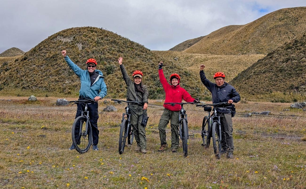 A group of four people with bicycles